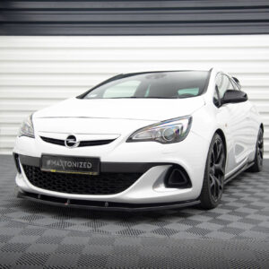 Front-left view of a white Opel hatchback in a bright showroom with a ribbed white wall backdrop