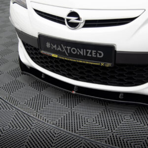 pol_po_FRONT-SPLITTER-suitable-for-Opel-ASTRA-J-OPC-VXR-v-1-837_4jpg - OPSHOLDERS Front view of a white Opel car showing the grille and a black plate with '#MAXTONIZED' text on a showroom floor patterning behind it.
