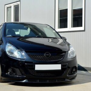 pol_po_FRONT-SPLITTER-suitable-for-Opel-CORSA-D-NURBURG-FOR-OPC-VXR-BUMPER-841_3jpg - OPSHOLDERS Black Opel hatchback car parked on a concrete lot in front of a gray building with white-framed windows, front view.