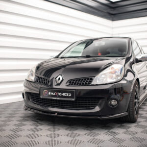 Front-left view of a glossy black Renault car in a bright showroom with striped walls, license plate reading #MAXTONIZED.