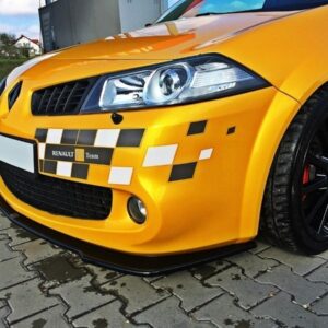 pol_po_FRONT-SPLITTER-suitable-for-Renault-MEGANE-II-RS-Facelift-871_3jpg - OPSHOLDERS Close-up of a bright yellow Renault sports car with checkerboard decals and black alloy wheels on a paved surface.