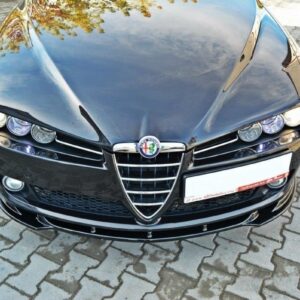 Front view of a shiny black Alfa Romeo sedan with its emblem on a brick-paved driveway, facing the camera.