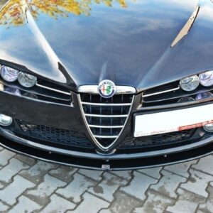 Front view of a black Alfa Romeo car parked on a cobblestone surface, showing the signature shield grille and dual headlights.