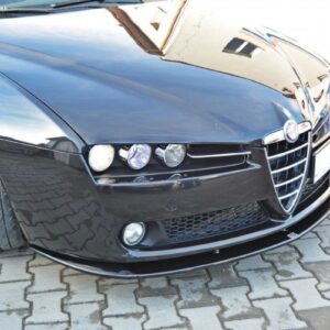 Front view of a black Alfa Romeo car parked on a brick driveway, front-left wheel turned outward.