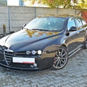 Black Alfa Romeo station wagon parked on a paved driveway, reflecting trees on the hood with large alloy wheels visible in a three-quarter front view.