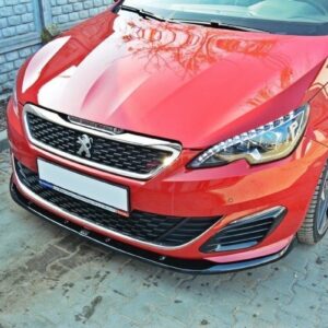 Front view of a red Peugeot car showing the logo, grille, and LED headlights parked on a paved surface.