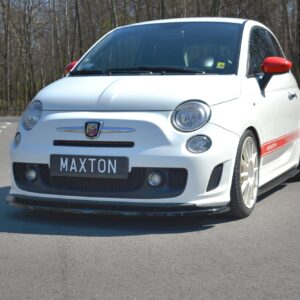 Front three-quarter view of a white Abarth hatchback with red side mirrors and red stripe along the side, parked in an empty lot with trees in the background.