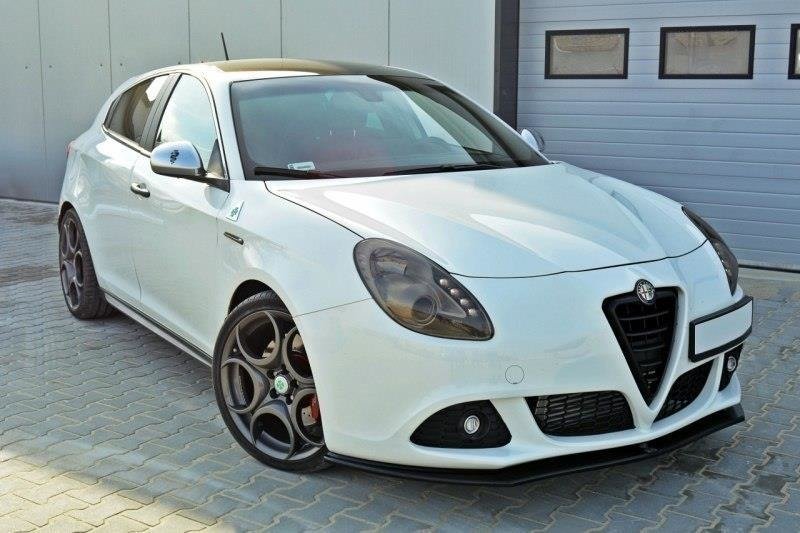 pol_po_Front-Splitter-V-1-suitable-for-Alfa-Romeo-Giulietta-415_2jpg - OPSHOLDERS White Alfa Romeo hatchback parked on gray pavers beside a light-gray building with a large garage door