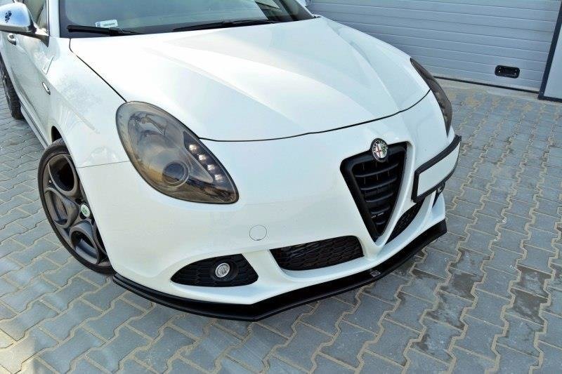 pol_po_Front-Splitter-V-1-suitable-for-Alfa-Romeo-Giulietta-415_3jpg - OPSHOLDERS White Alfa Romeo front view with black lower lip, parked on a brick driveway near a garage door.