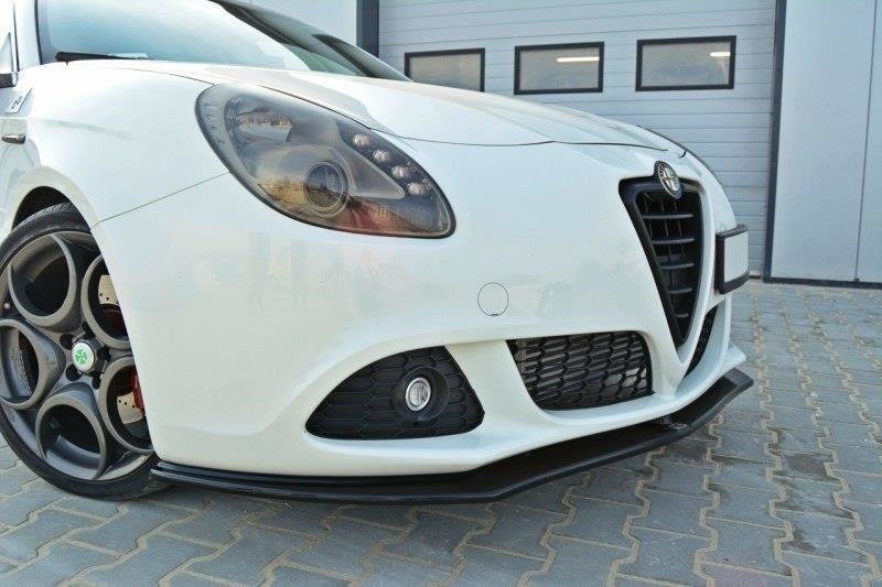 pol_po_Front-Splitter-V-1-suitable-for-Alfa-Romeo-Giulietta-415_4jpg - OPSHOLDERS Close-up of a white Alfa Romeo front end, showing headlight, grille, and lower bumper with fog light on the left side.