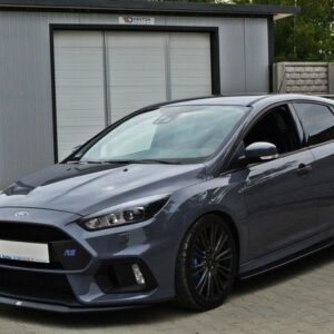 Grey Ford Focus RS hatchback parked on a driveway in front of a modern metal shed, posing for a photo.