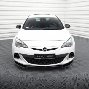 Front view of a white Opel car in a showroom, facing the camera, with a black grille and a '#MAXTONIZED' plate text visible on the bumper