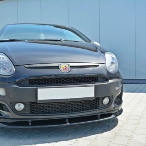 Front view of a dark gray Abarth hatchback with honeycomb grille, large bumper vents, and rounded headlights parked on a paved driveway in front of a blue industrial building.
