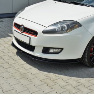 Close-up of a white sports car's front left: headlight, red-accent grille with Abarth badge, and black wheel with red brake calipers.