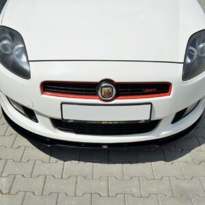 Front view of a white sports car with rounded headlights, red-accented grille, and Abarth emblem on a paved surface.
