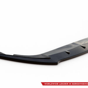 Glossy dark gray aerodynamic front splitter/spoiler with multiple vents, shown diagonally on a white background, logo and red banner text in the corner.”