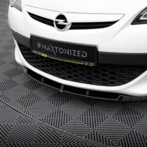 Front view of a white Opel car showing the emblem and a license plate reading #MAXTONIZED on a dark frame.