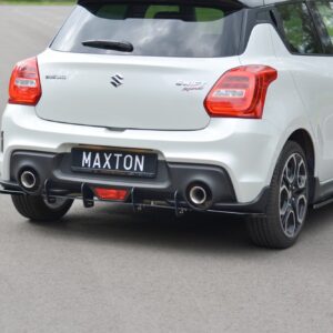Rear view of a white Suzuki Swift Sport hatchback with blue graphic wrap and black MAXTON license plate, showing dual exhausts and sporty rear bumper.