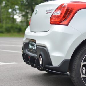 Rear view of a white Suzuki Swift Sport, showing the prominent red tail light and rear bumper in a parking lot.
