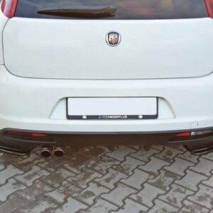 Rear view of a white hatchback showing dual exhausts on the left and an Abarth badge, parked on brick pavers.