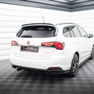Rear three-quarter view of a white Fiat Tipo hatchback parked in a bright, modern showroom with white paneled walls and a textured floor.