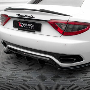 White Maserati rear view with Maxton design license plate and red taillights on a patterned floor, sports car setting