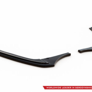 Pair of black curved aerodynamic car parts placed on a white studio background, brand logo visible in the corner.
