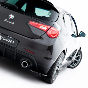 Rear view of a black Alfa Romeo Giulietta hatchback with red taillights and the #MAXTONIZED plate.
