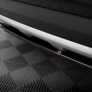 Close‑up of a car's side skirt with a white trim and a small Maxton Design badge visible under glossy black paint scope (car accessory).