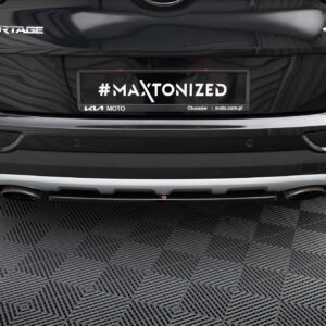 Rear view of a black Kia Sportage with a custom plate reading '#MAXTONIZED' and 'KIA MOTO' branding beneath it.