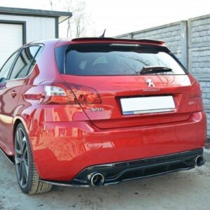 Red Peugeot 308 GTi hatchback rear view in a driveway with dual exhausts and sporty diffuser.