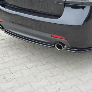 pol_po_Rear-Splitter-suitable-for-Saab-9-3-Aero-Mk2-Facelift-1054_2jpg - OPSHOLDERS Rear view of a black car showing a single chrome exhaust tip, red reflectors, and bumper trim on a paved surface.