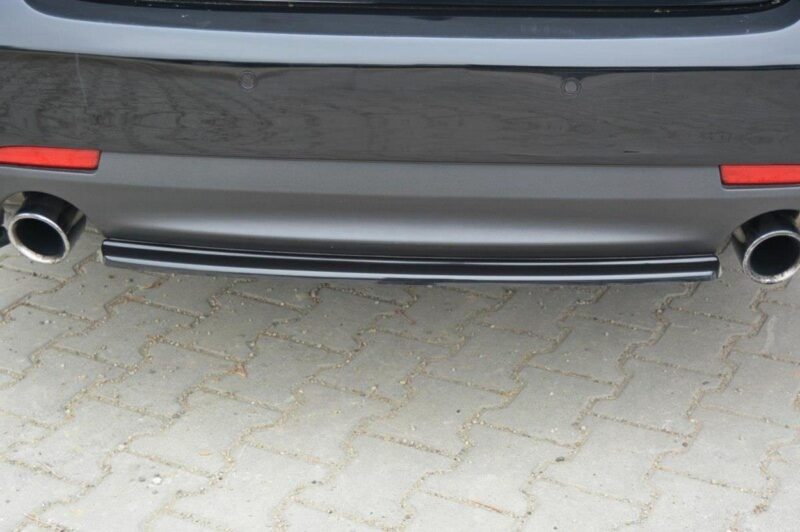 pol_po_Rear-Splitter-suitable-for-Saab-9-3-Aero-Mk2-Facelift-1054_4jpg - OPSHOLDERS Rear view of a gray car showing dual chrome exhaust pipes and a low-profile bumper on a brick-paved surface.