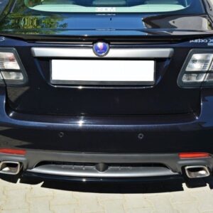 Rear view of a dark Saab 9-3 Turbo X parked on a paved surface, showing taillights, license plate area, and dual exhausts with chrome tips.