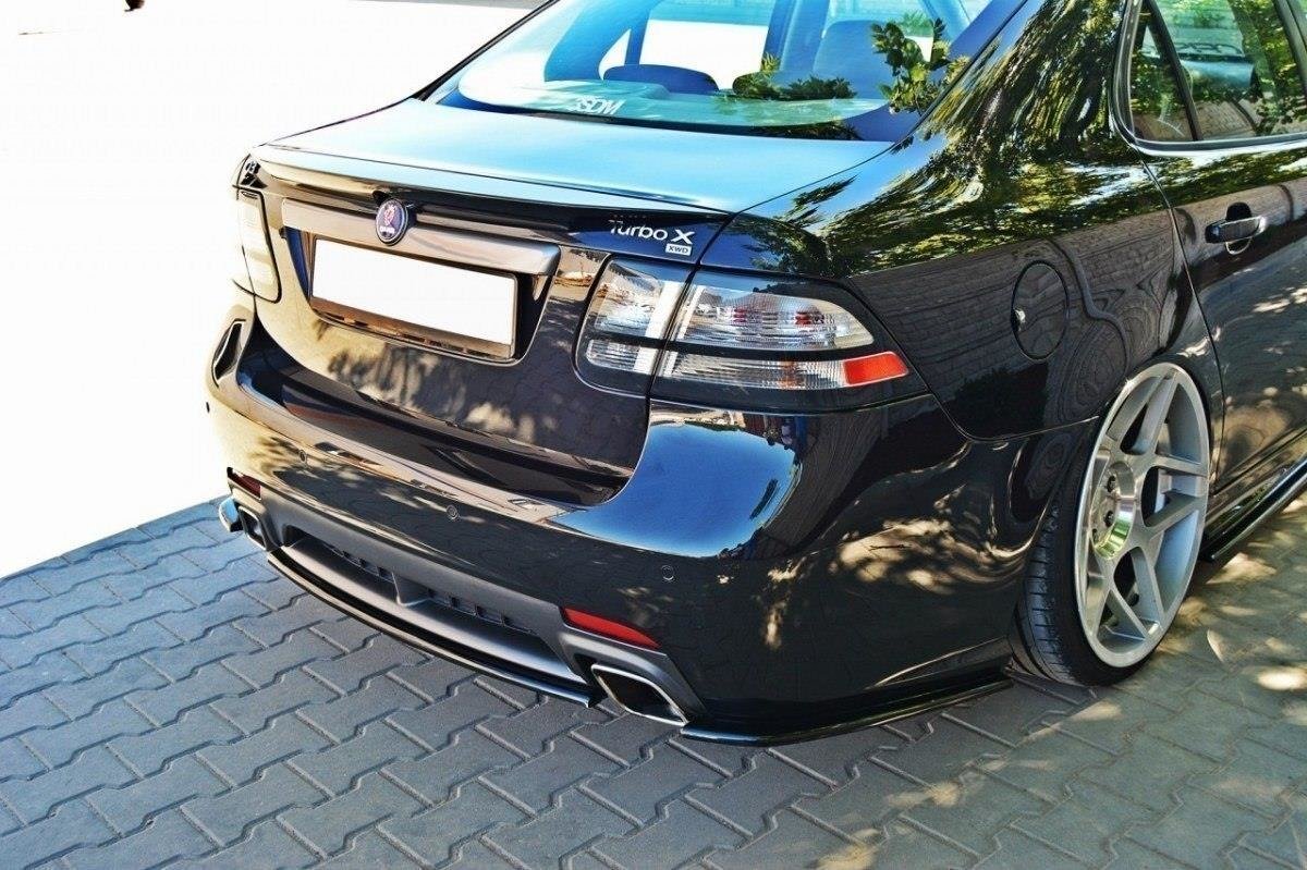 pol_po_Rear-Splitter-suitable-for-Saab-9-3-TURBO-X-1055_3jpg - OPSHOLDERS Rear view of a glossy black car with large silver aftermarket wheels and quad exhausts on a brick-paved surface