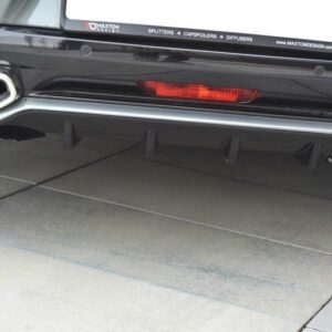 Rear view of a black car's bumper with dual chrome exhaust tips, a red rear reflector, and a sporty diffuser with fins