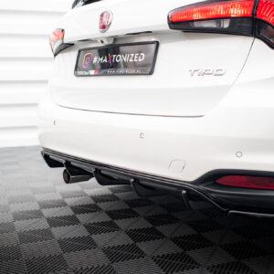 Rear view of a white Fiat Tipo with red taillights and a custom license plate reading #MAKTONIZED, parked indoors on a checkered floor.