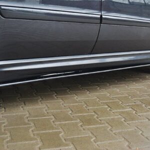 pol_po_SIDE-SKIRTS-DIFFUSERS-suitable-for-Opel-ZAFIRA-B-OPC-254_3jpg - OPSHOLDERS Close-up side view of a dark car showing the lower side skirt, door, and alloy wheels on a brick-paved surface, with light scuffs near the bottom edge.