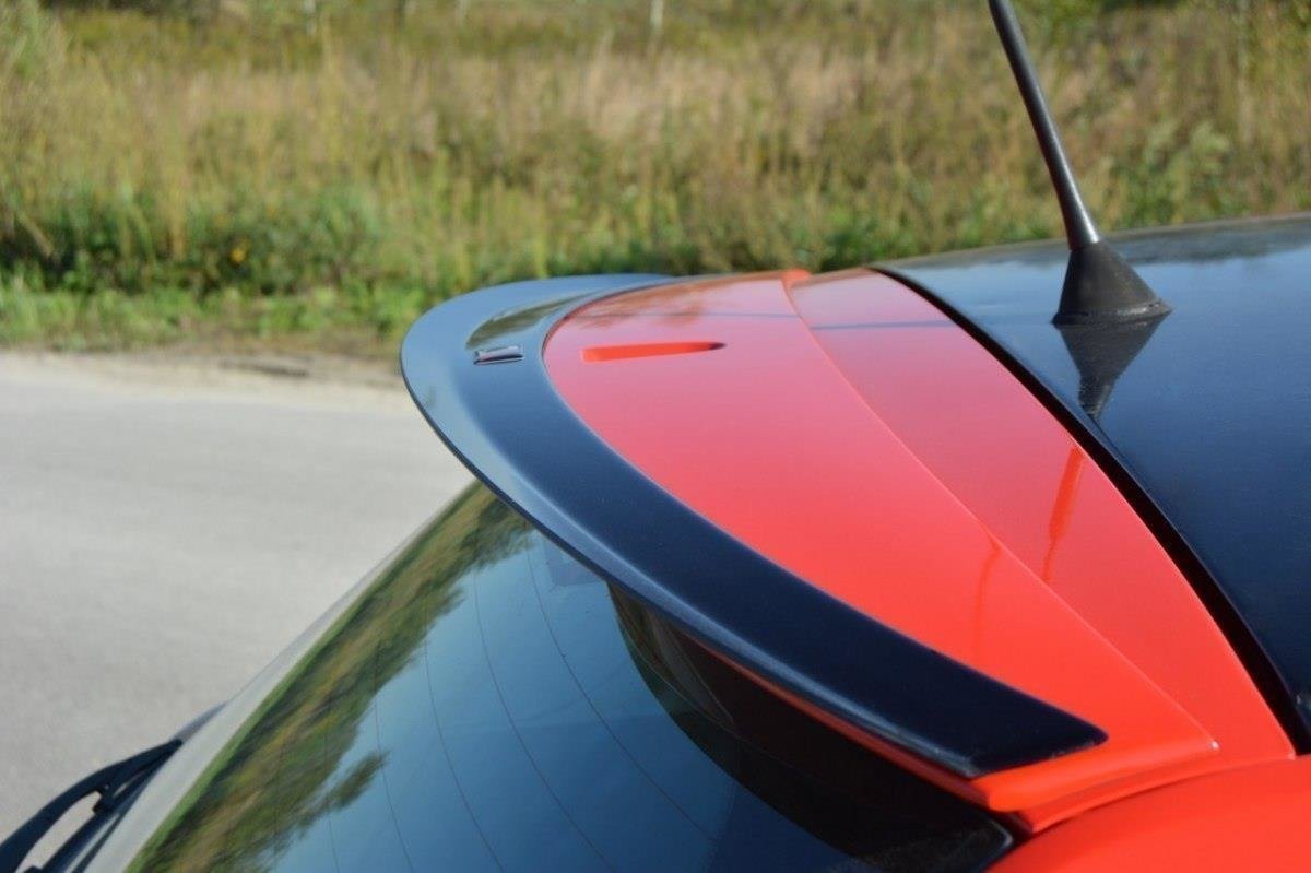 pol_po_SPOILER-CAP-suitable-for-Fiat-STILO-SCHUMACHER-VERSION-1271_2jpg - OPSHOLDERS Close-up of a red sports car's rear spoiler with a black edge, outdoors on a sunny day