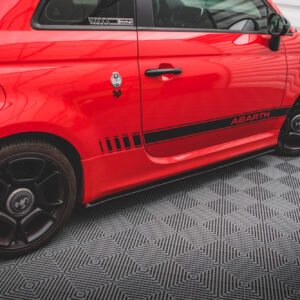 Red Abarth car side profile with a black door handle, badge reading 595, and black alloy wheels, parked on a patterned floor.