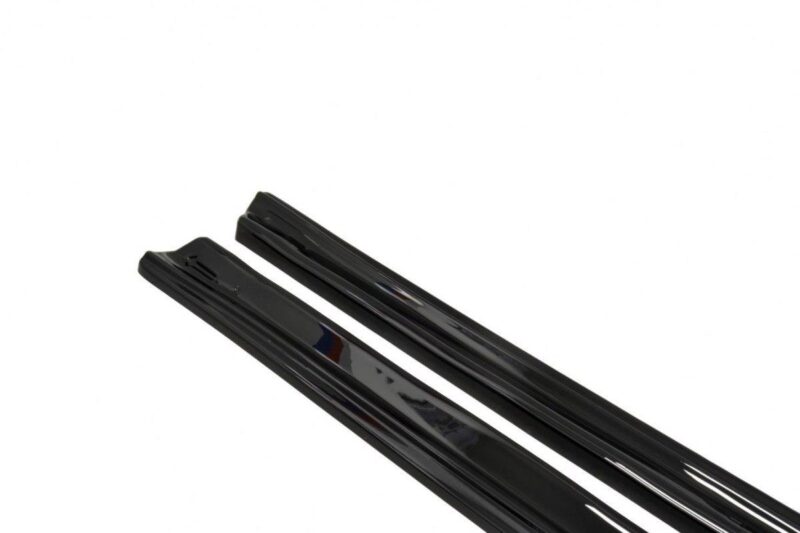 Pair of black windshield wiper blades lying side by side on a white background