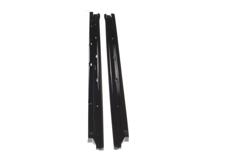 Pair of black ski bindings standing upright on a white background