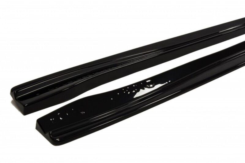 Pair of glossy black car side sill trim pieces shown on a white background (protective/decorative molding for vehicle doors).