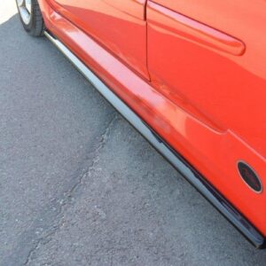pol_po_Side-Skirts-Diffusers-suitable-for-Fiat-Stilo-Schumacher-2784_3jpg - OPSHOLDERS Red car with a black side skirt along the lower body, wheel visible on the right, on asphalt.
