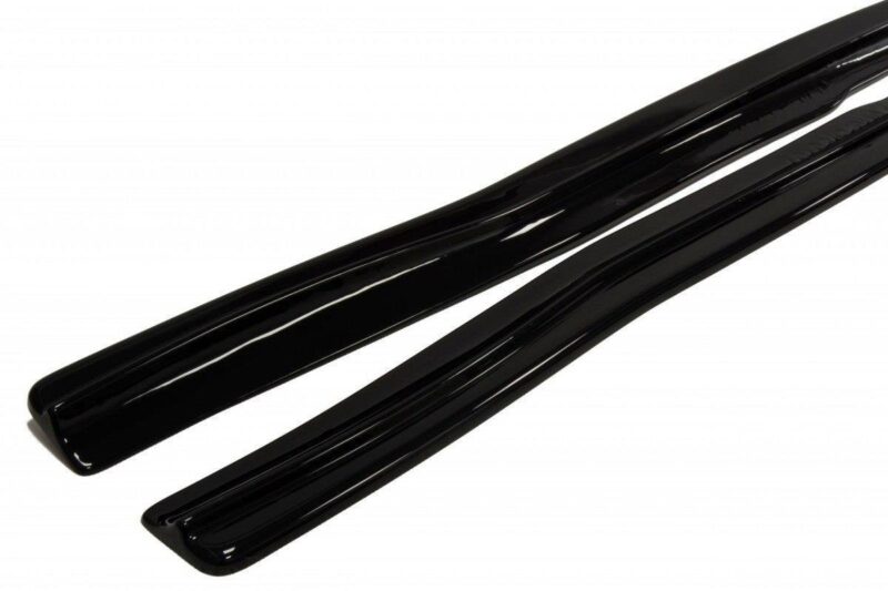 Two long, glossy black cylindrical tubes resting on a white background.