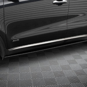 Close-up of a black SUV side panel with an AWD badge, chrome door handle, and chrome trim along the bottom edge amid reflections.