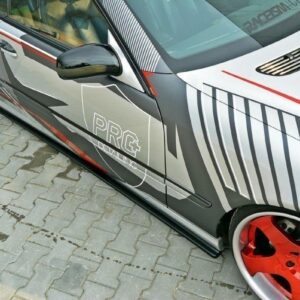 Close-up of a customized gray car with red rims and graphic wrap reading PRG Tuning on the side.
