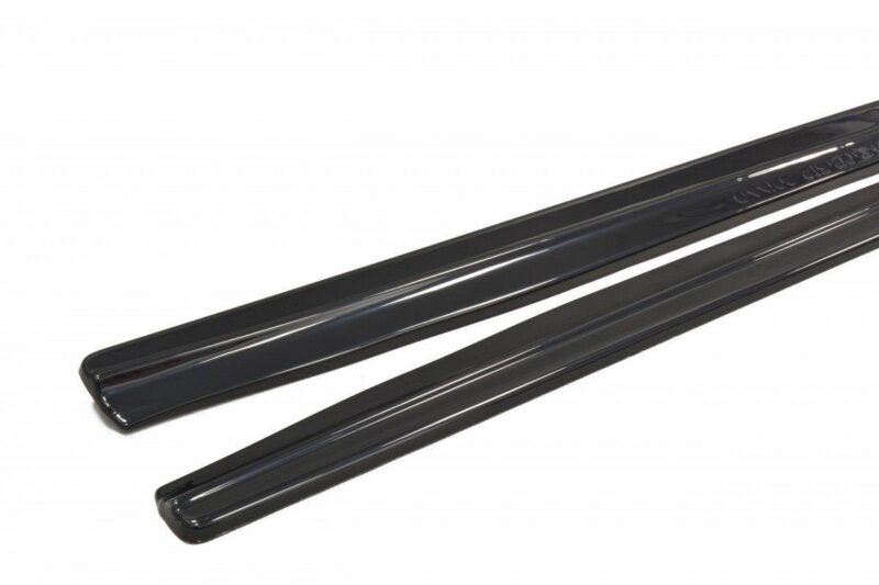 Pair of glossy black car running boards/side steps on a white background