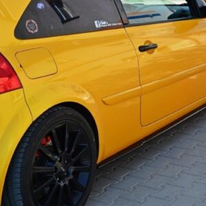Yellow sporty car parked on a brick driveway, black multi-spoke wheels, red brake calipers visible through rims, rear quarter panel and door shown.