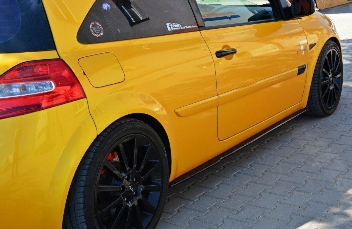 pol_po_Side-Skirts-Diffusers-suitable-for-Renault-Megane-RS-Mk2-276_2jpg - OPSHOLDERS Yellow sporty car parked on a brick driveway, black multi-spoke wheels, red brake calipers visible through rims, rear quarter panel and door shown.